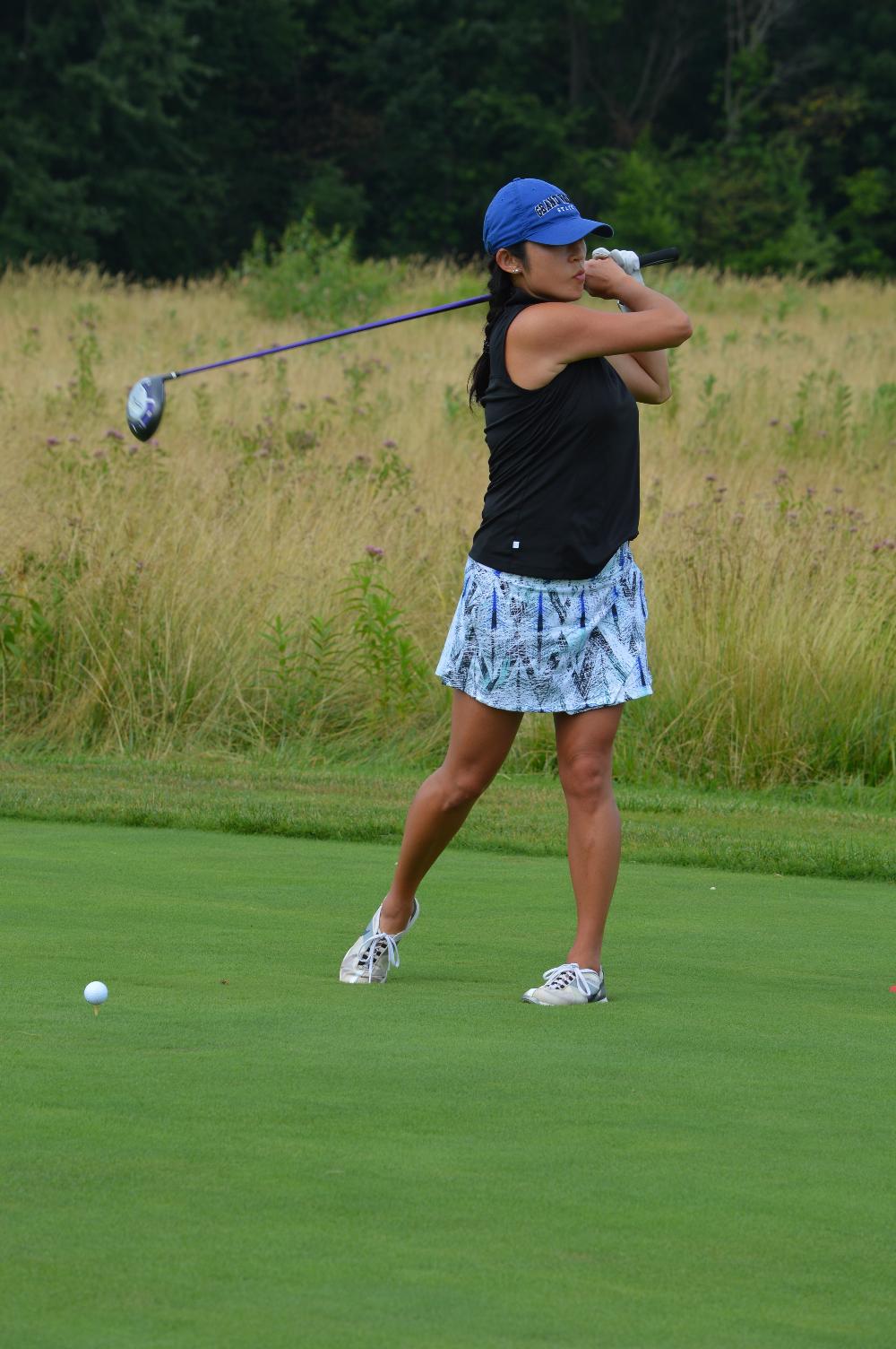 An alumna golfing at the Meadows Golf Course.